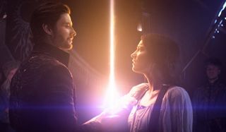 Ben Barnes and Jessie Mei Li stand around a very powerful light in Shadow and Bone