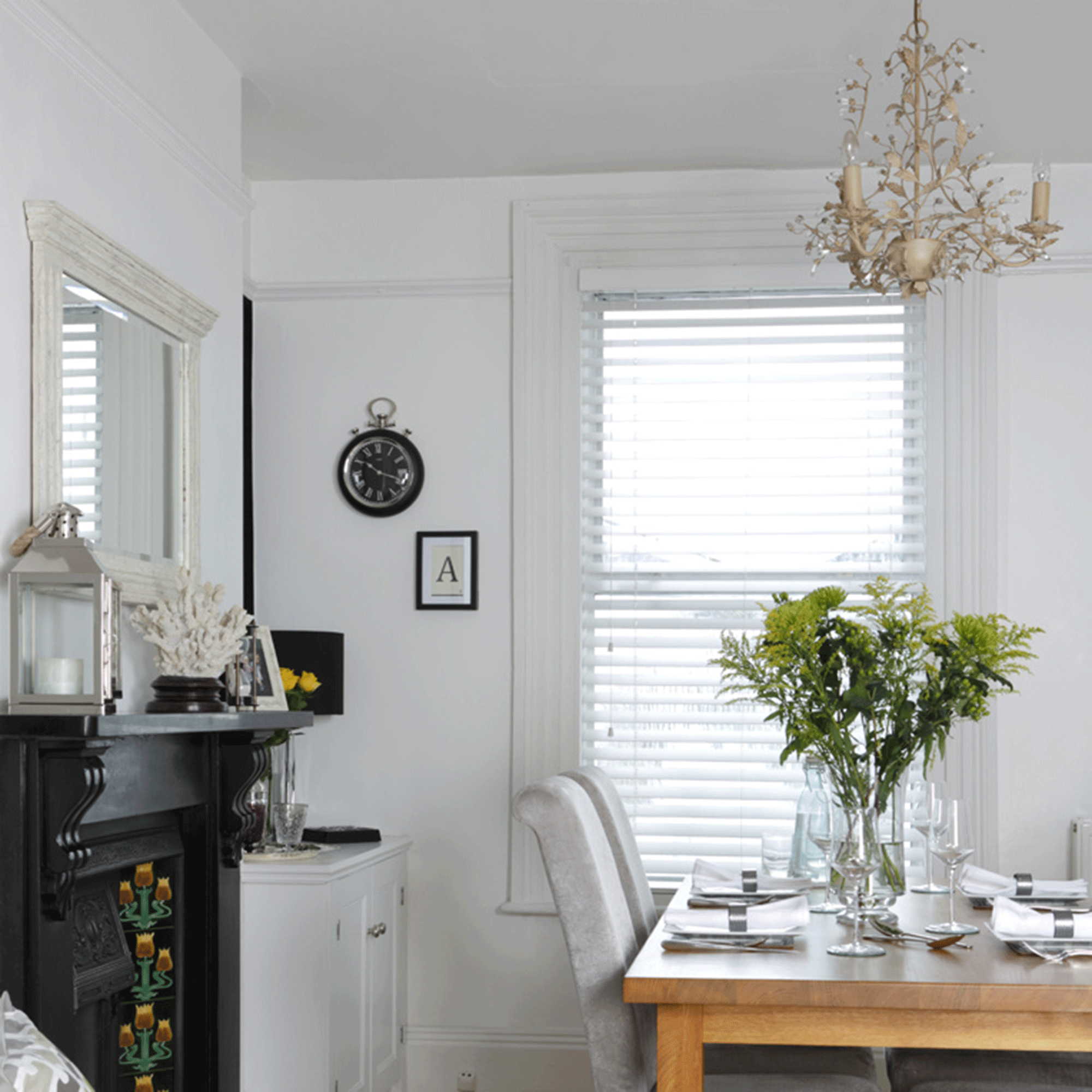 White dining room with wooden table