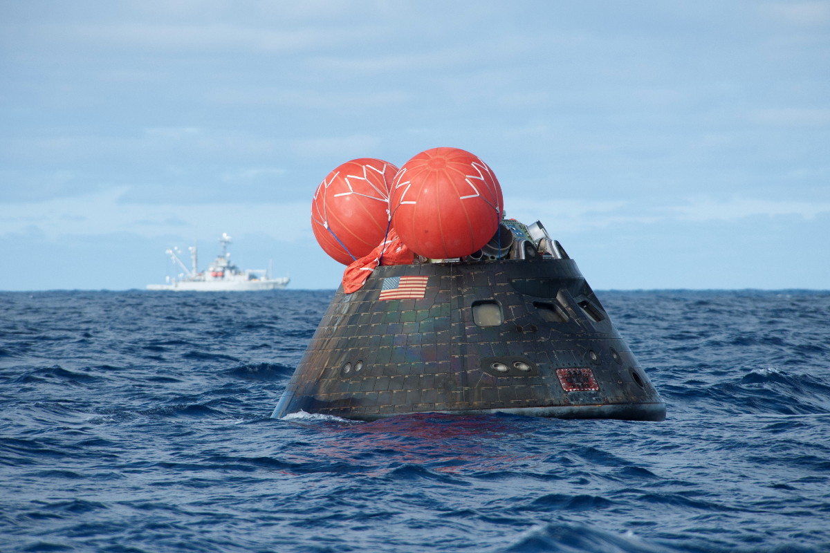 NASA&#039;s Orion spacecraft floats in the Pacific Ocean after its first uncrewed test flight on Dec. 5, 2014. The capsule was retrieved by the U.S. Navy&#039;s USS Anchorage.