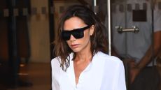 Victoria Beckham wearing crisp white shirt, laid back jeans and black toe-strap sandals in Soho on September 9, 2016.