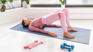 image shows woman using resistance band to stretch