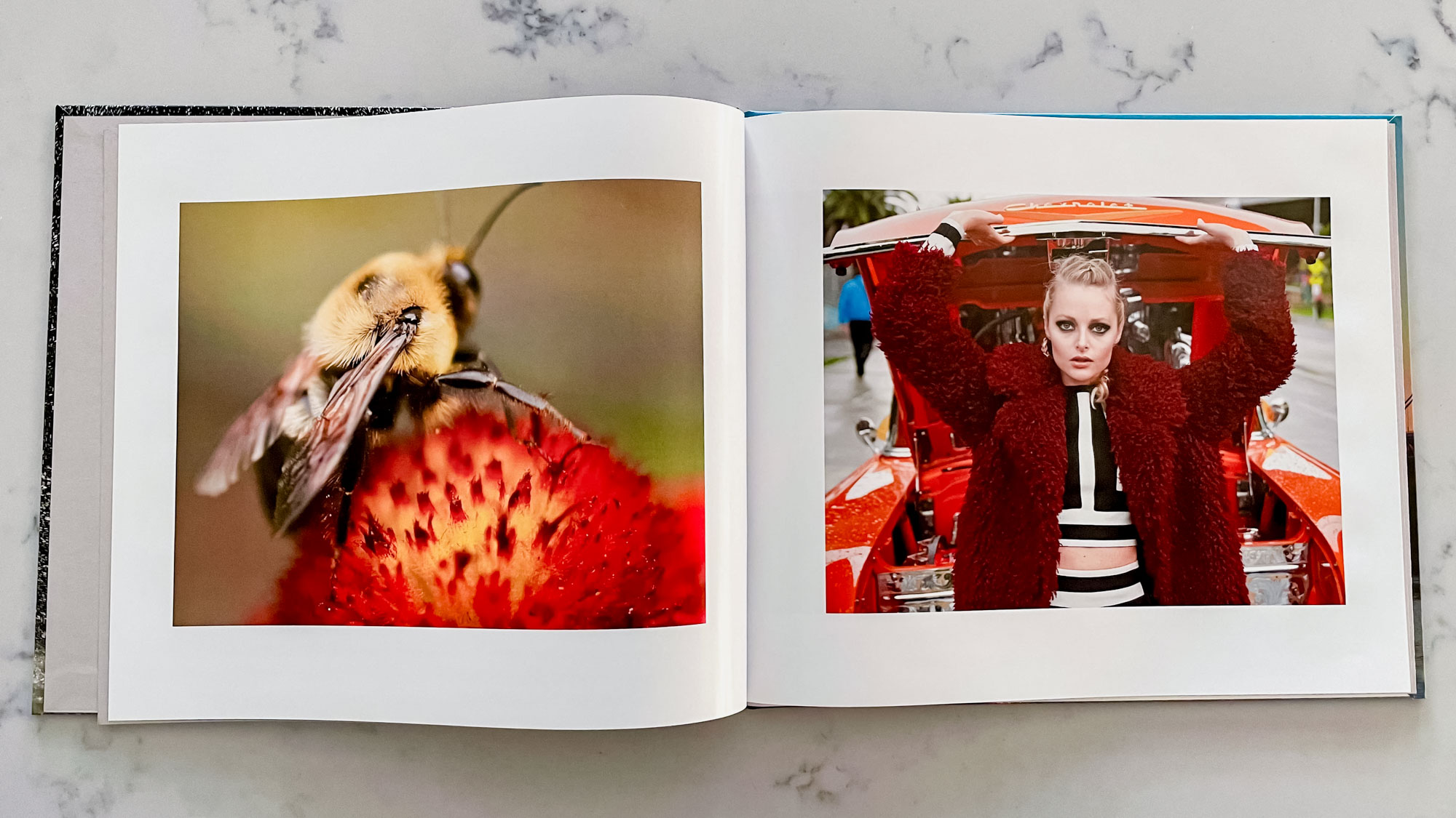 A Blurb photo book open on a countertop surface