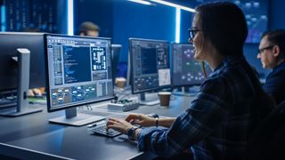 A cyber security professional at their desk in an office