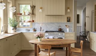 vintage kitchen with cream walls marble splashback and vintage lighting