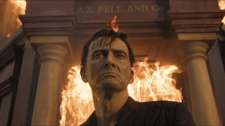 Crowley in front of Aziraphale's burning bookshop in Good Omens Season 1