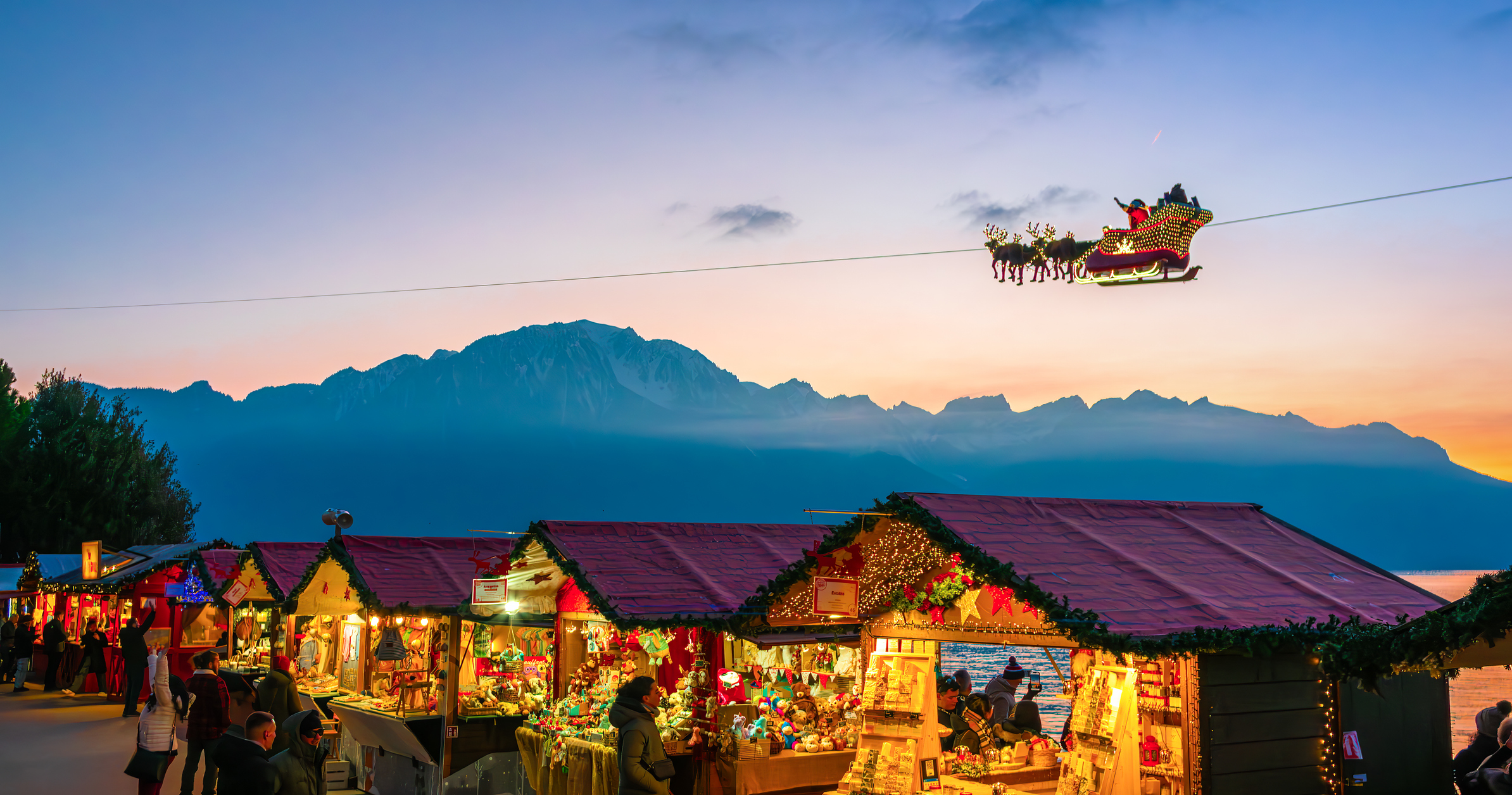 Christmas Market Stalls and flying Santa in Montreux by Lakeside at Sunset