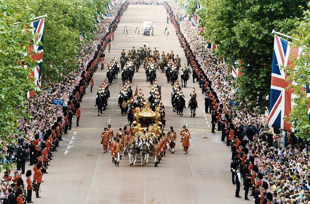 The Gold State Coach passing by Admiralty Arch taking the Queen and Prince Philip The Golden Jubilee Service in 2002, escorted by the Household Cavalry.