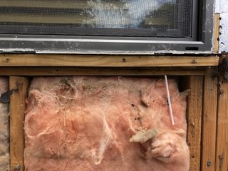 Rotted wood and insulation damaged by water on a home