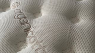 Close up of pillow top cover on Saatva Classic mattress during our review process