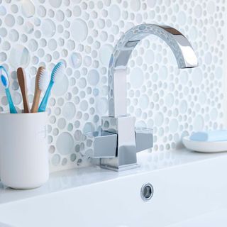 bathroom with mixer tap and circular tiles