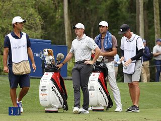 rory mcilroy waits on a golf course