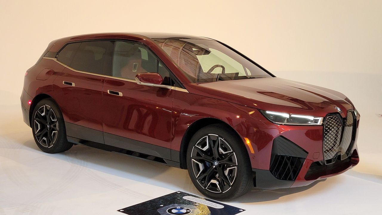 BMW iX sitting in a showroom