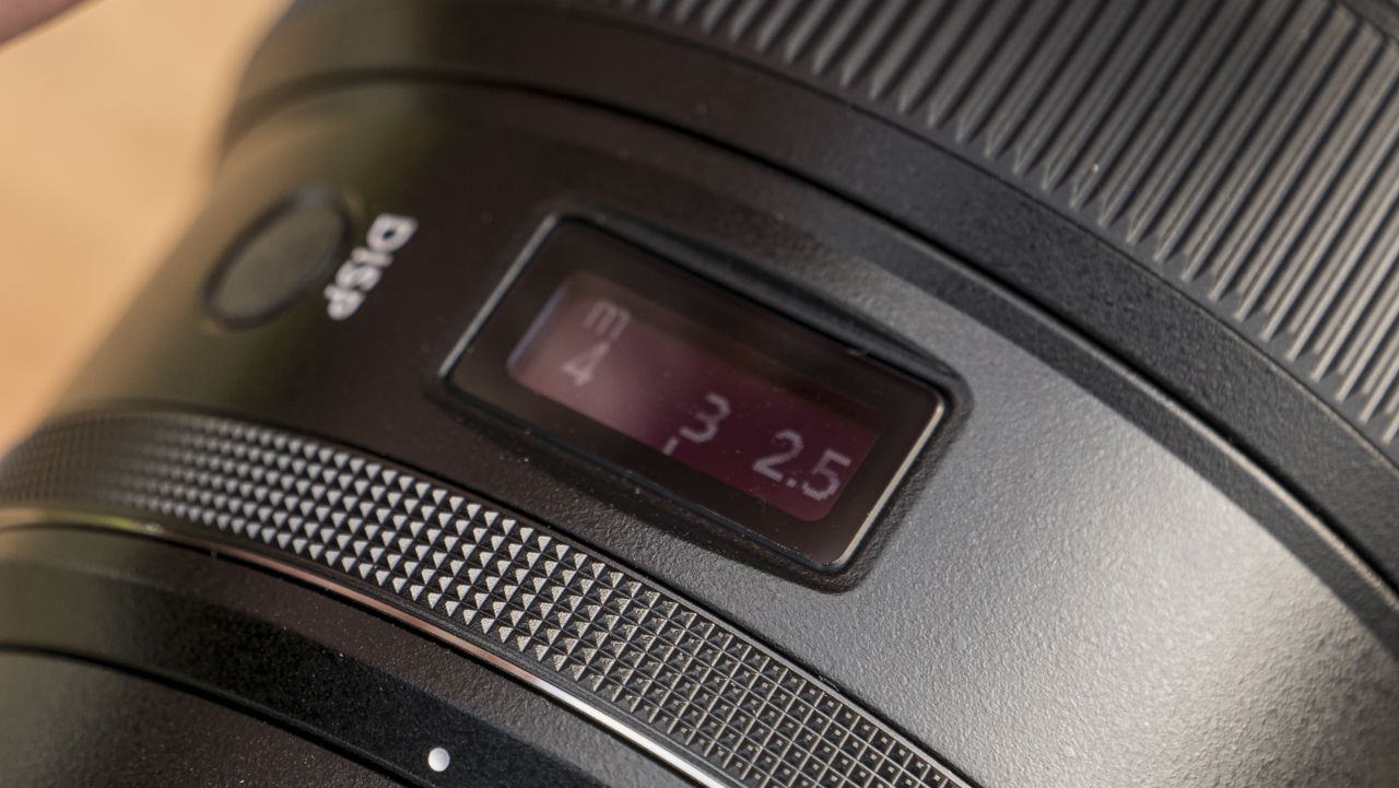 A Nikon Z telephoto lens on a wooden table