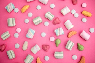 an assortment of sweets on a pink background