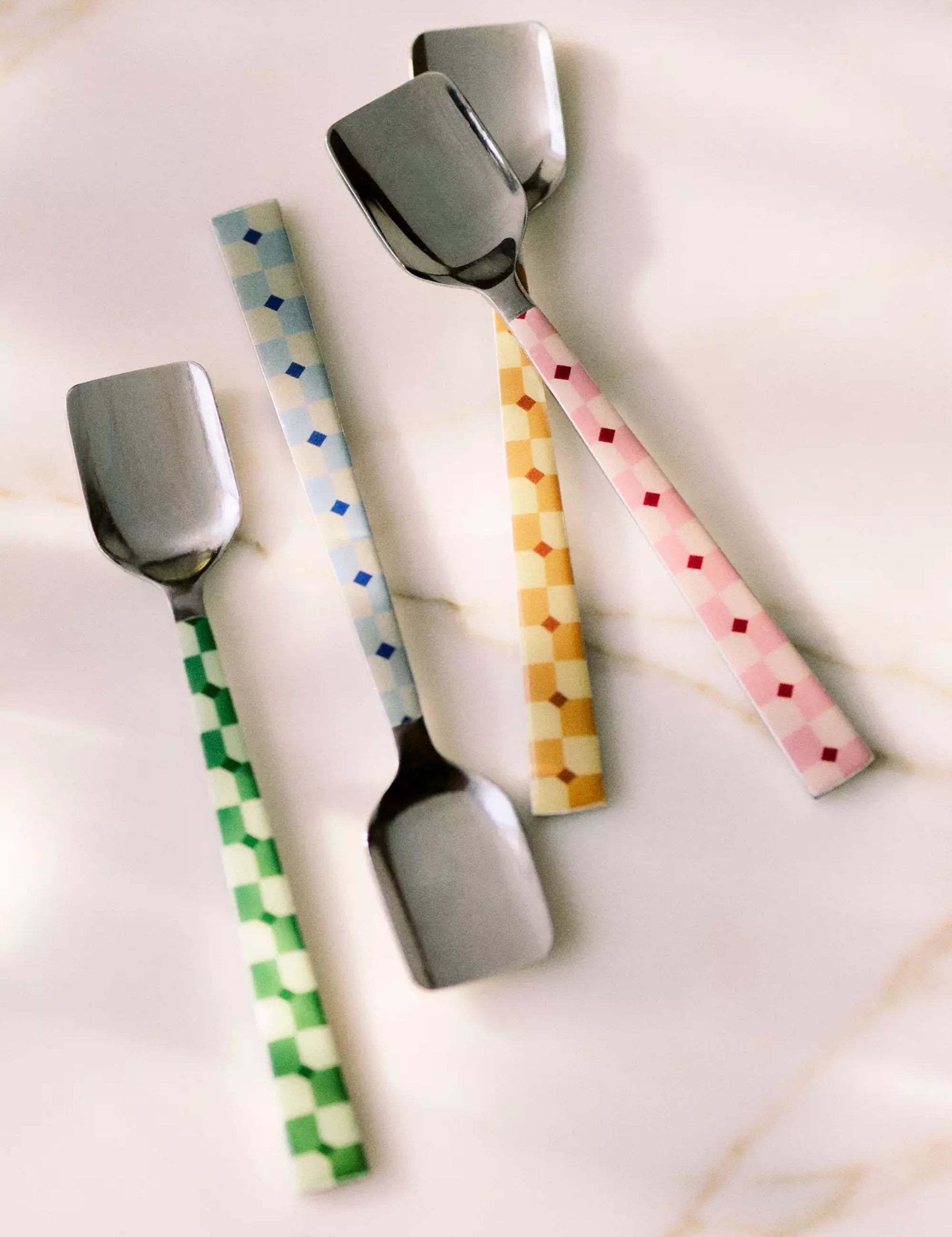 four set of colorful serving spoons with checkerboard pattern