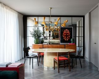 retro luxe dining room with mid century chairs and table and light fixture