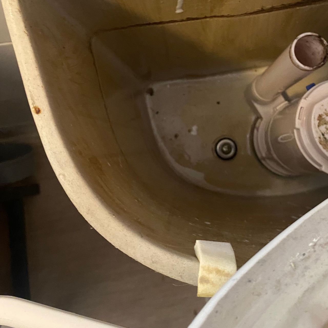Inside a toilet cistern, showing the bolt that connects the cistern to the bowl