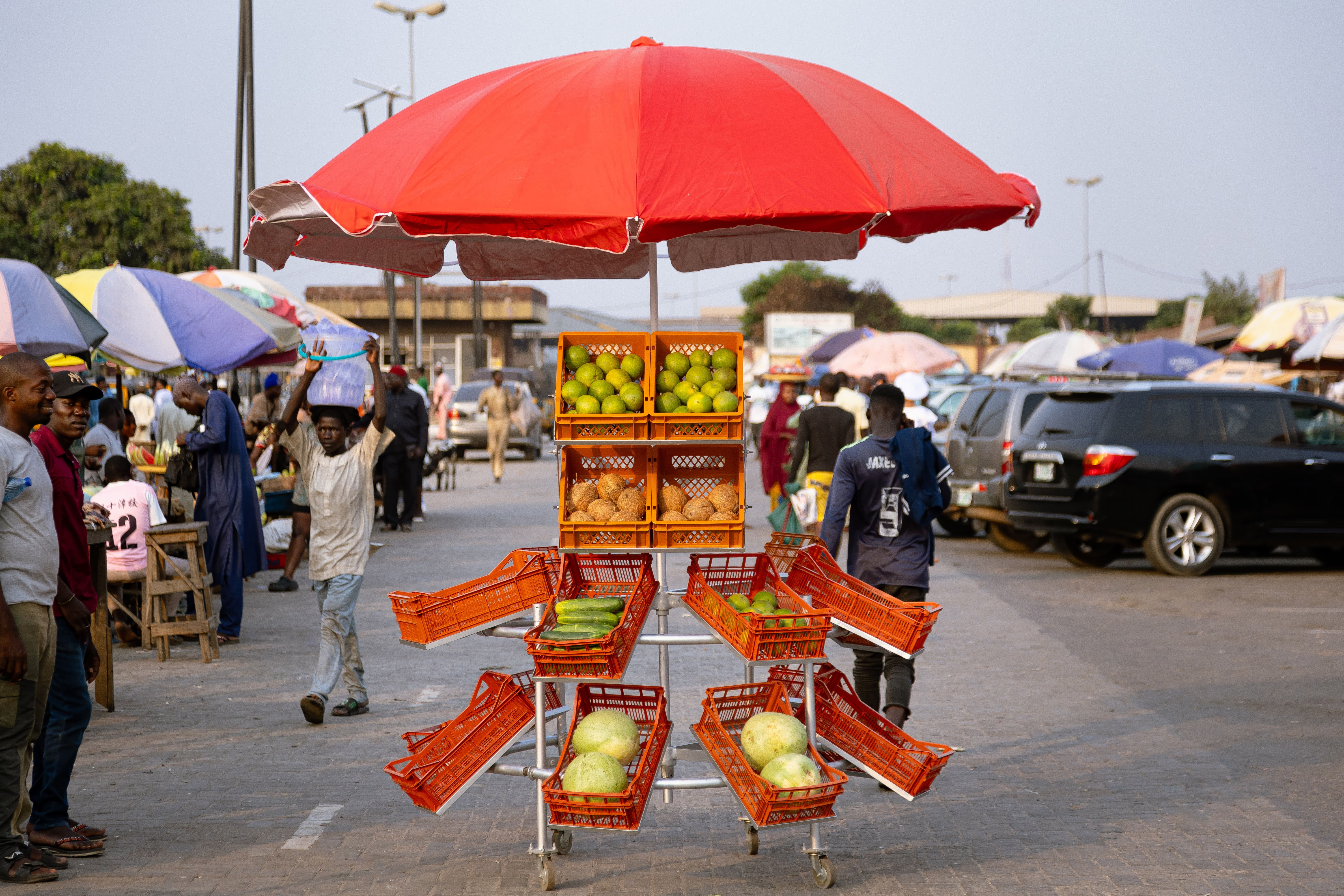 Metal street market stall with red umbrella