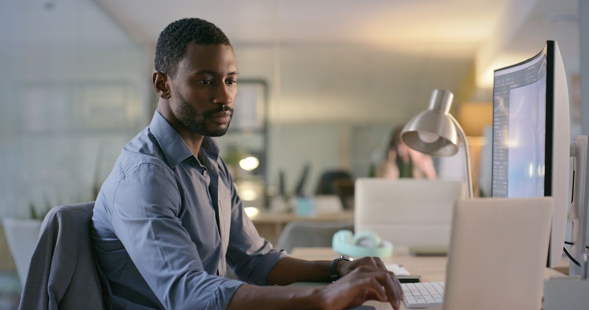 Public sector security practitioner sitting at a desk in a government office