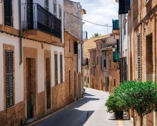 Narrow street of historical town part of Alcudia with its traditional house and architecture - Buy property in Europe
