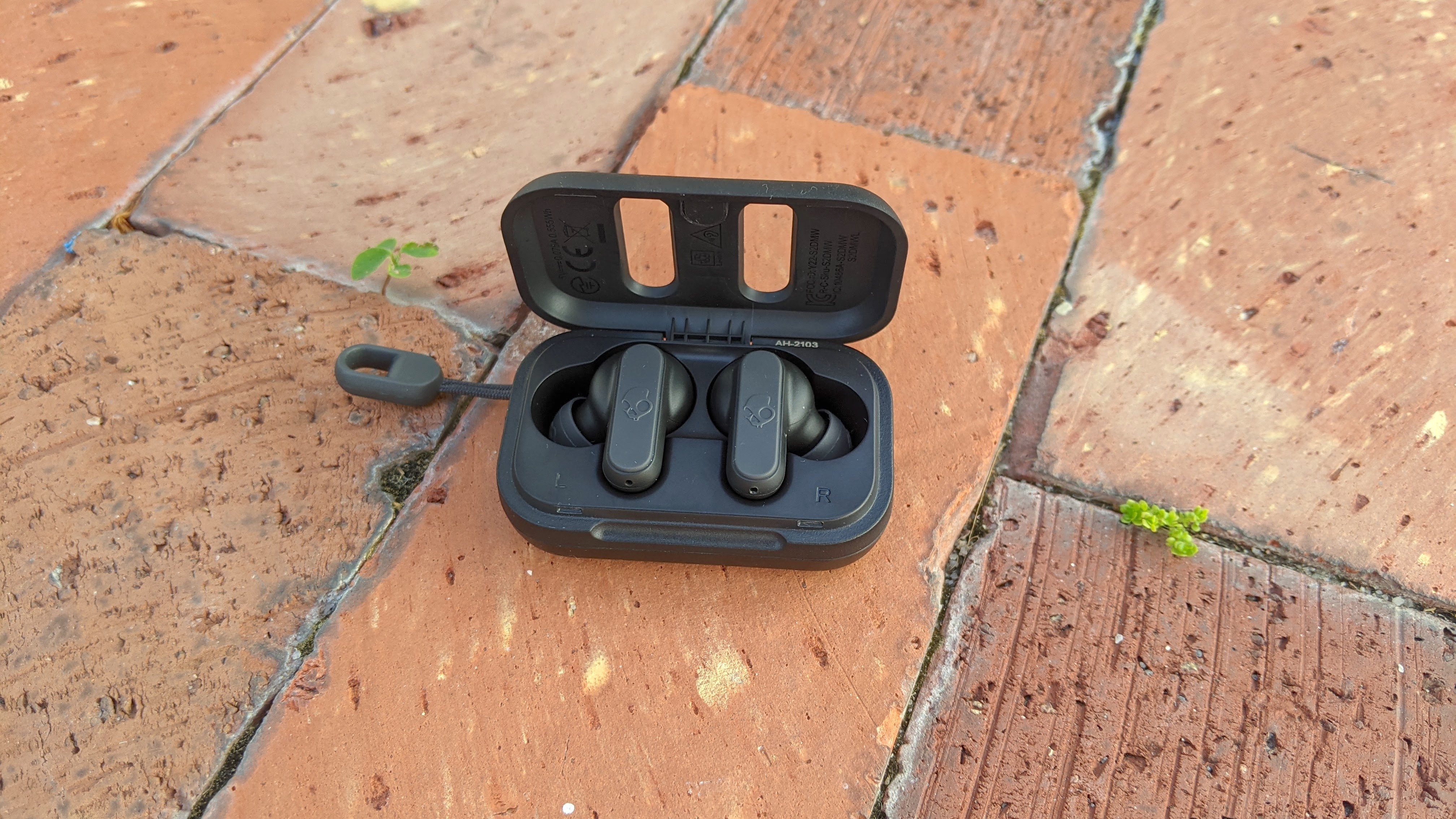 The Skullcandy Dime displayed on a brick floor