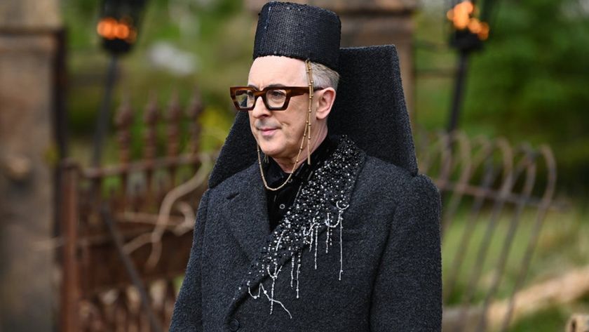 Alan Cumming wearing an iconic black outfit outfit in The Traitors