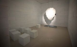 Ice room displaying white cubes and sculpture on wall