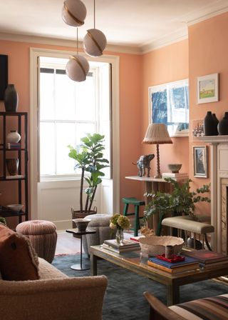 Living room with orange walls, plants and art