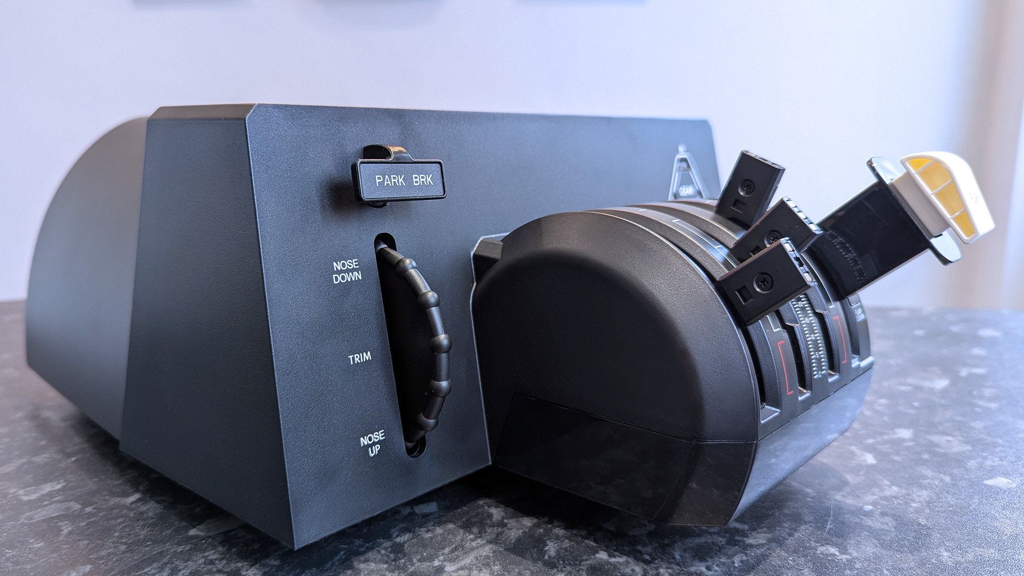 Honeycomb Aeronautical Bravo Throttle Quadrant Lite on a marble desk highlighting individual parts