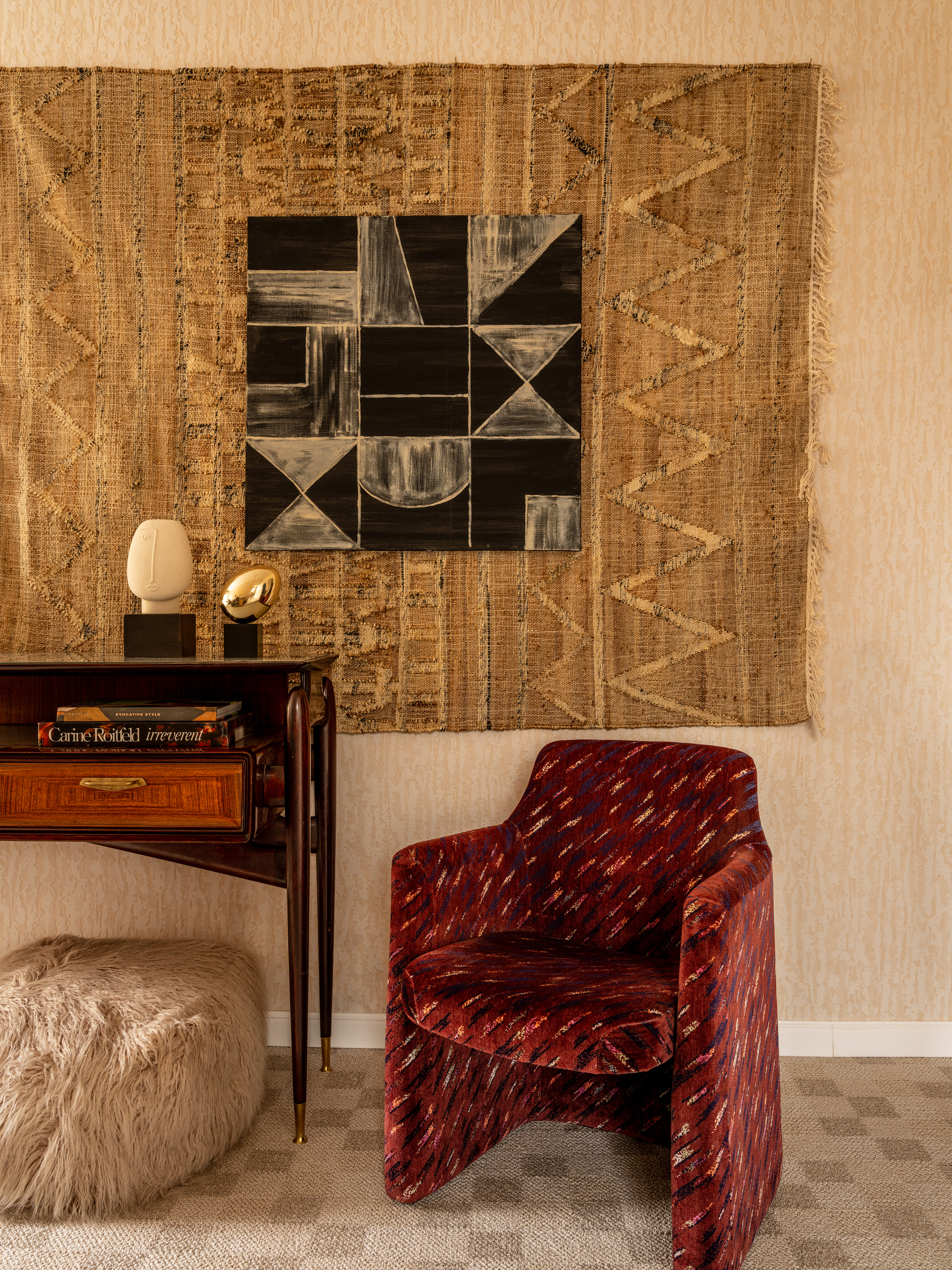 Red patterned chair in a neutral eclectic space