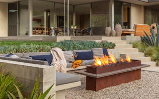 A firepit in the center of a seating area