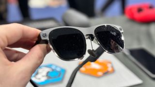 XREAL Air 2 Ultra XR glasses held over a table at CES 2024