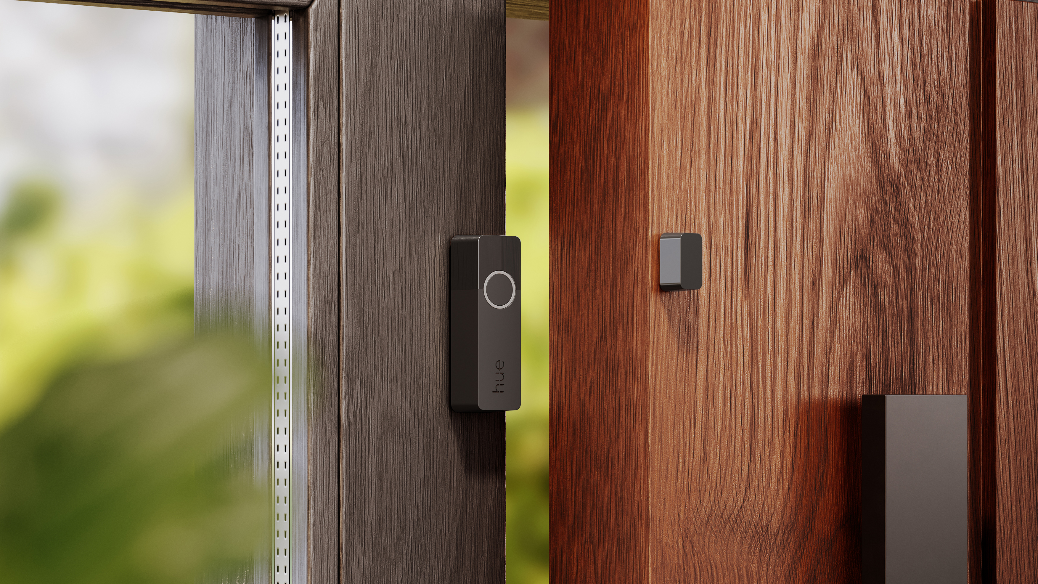 A Philips Hue Secure contact sensor on the inside of a doorway