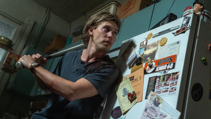 Hank (Austin Butler) readies a baseball bat in his kitchen inside his apartment in a scene from &quot;Caught Stealing&quot;