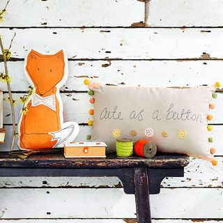 console table with fox and pom pom cushion