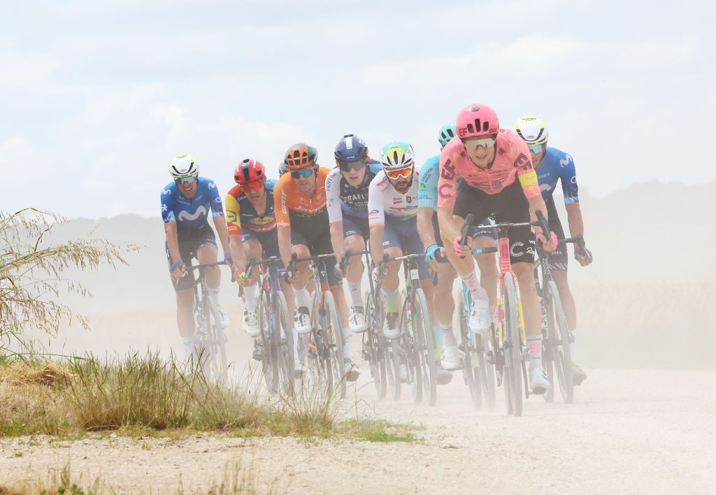 TROYES FRANCE JULY 07 LR Anthony Turgis of France and Team TotalEnergies Neilson Powless of of The United States and Team EF Education EasyPost and Javier Romo Oliver of Spain and Movistar Team compete in the breakaway passing through a gravel strokes sector during the 111th Tour de France 2024 Stage 9 a 199km stage from Troyes to Troyes UCIWT on July 07 2024 in Troyes France Photo by Etienne Garnier PoolGetty Images