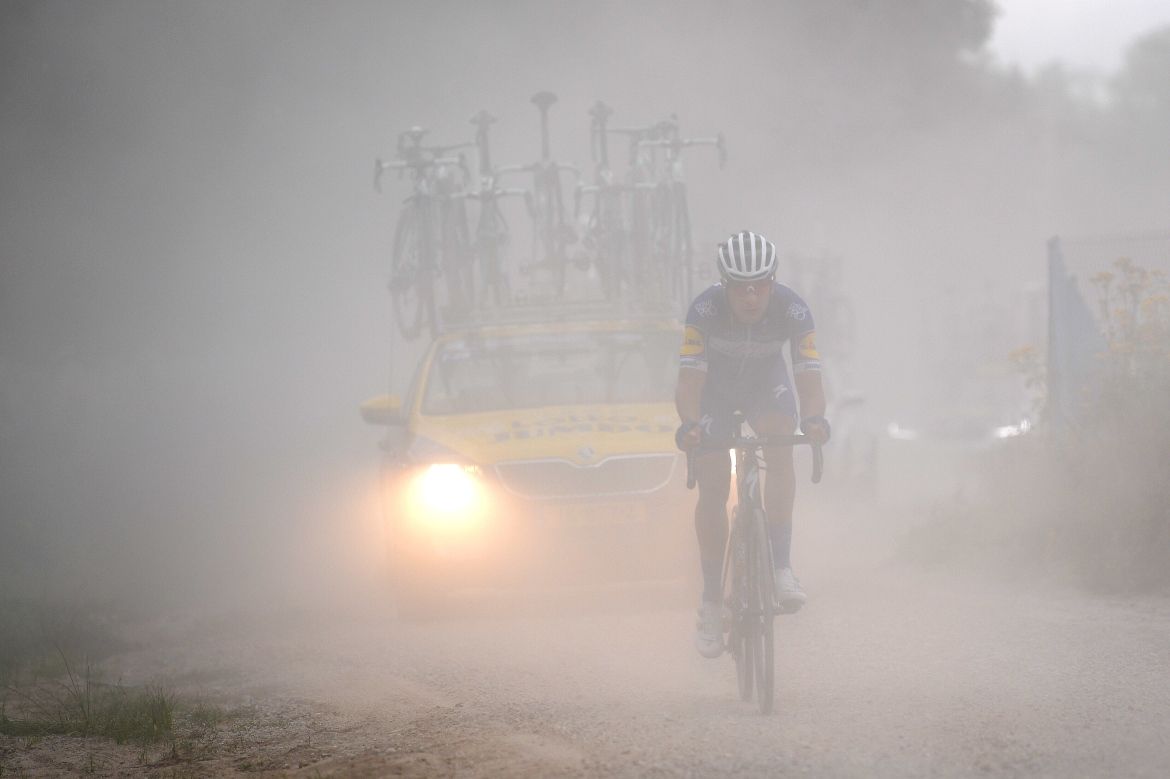 Davide Martinelli (Quick-Step) in the dust of the gravel road on stage 7