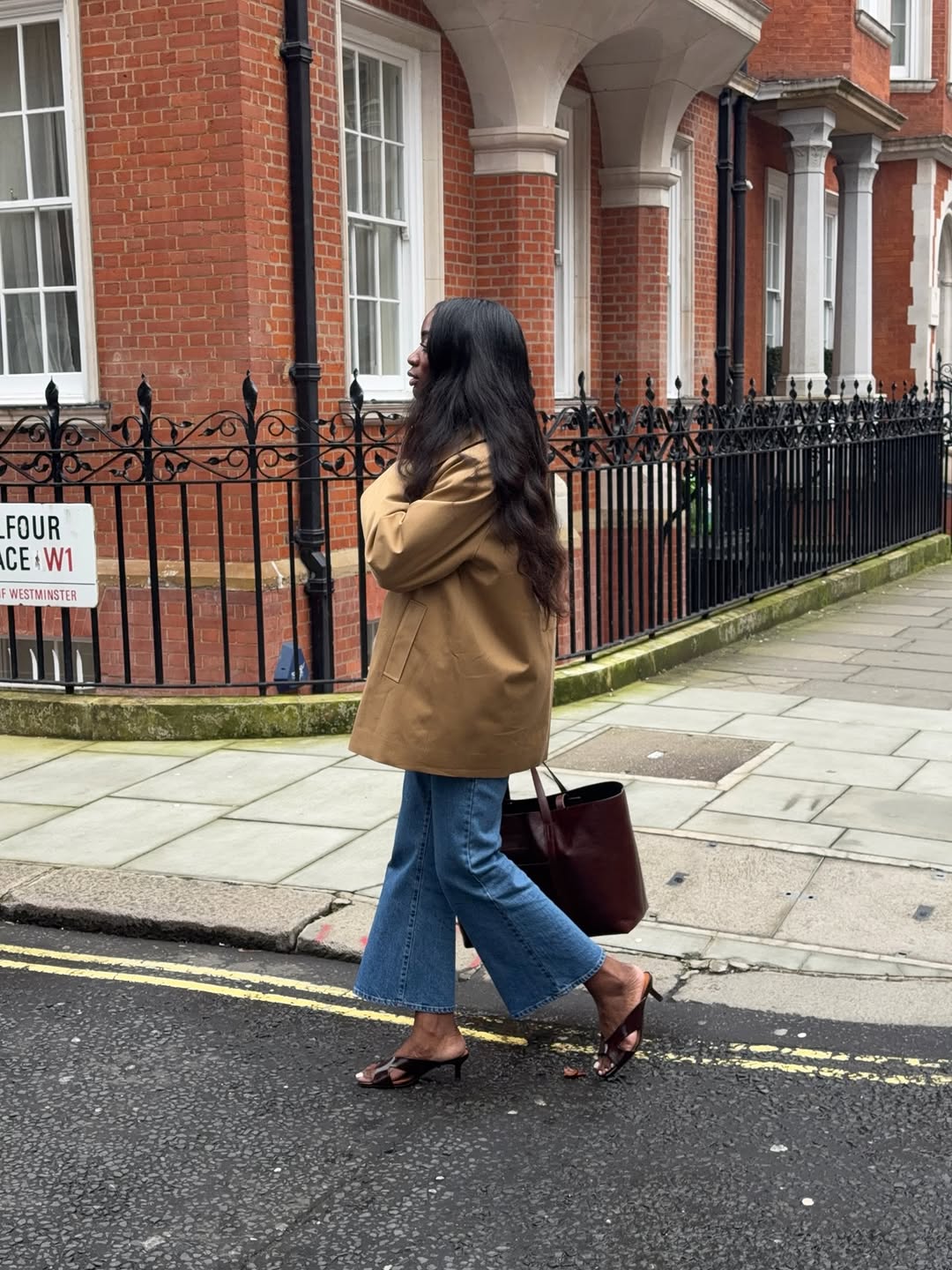 woman wearing heels with jeans spring outfit 2026