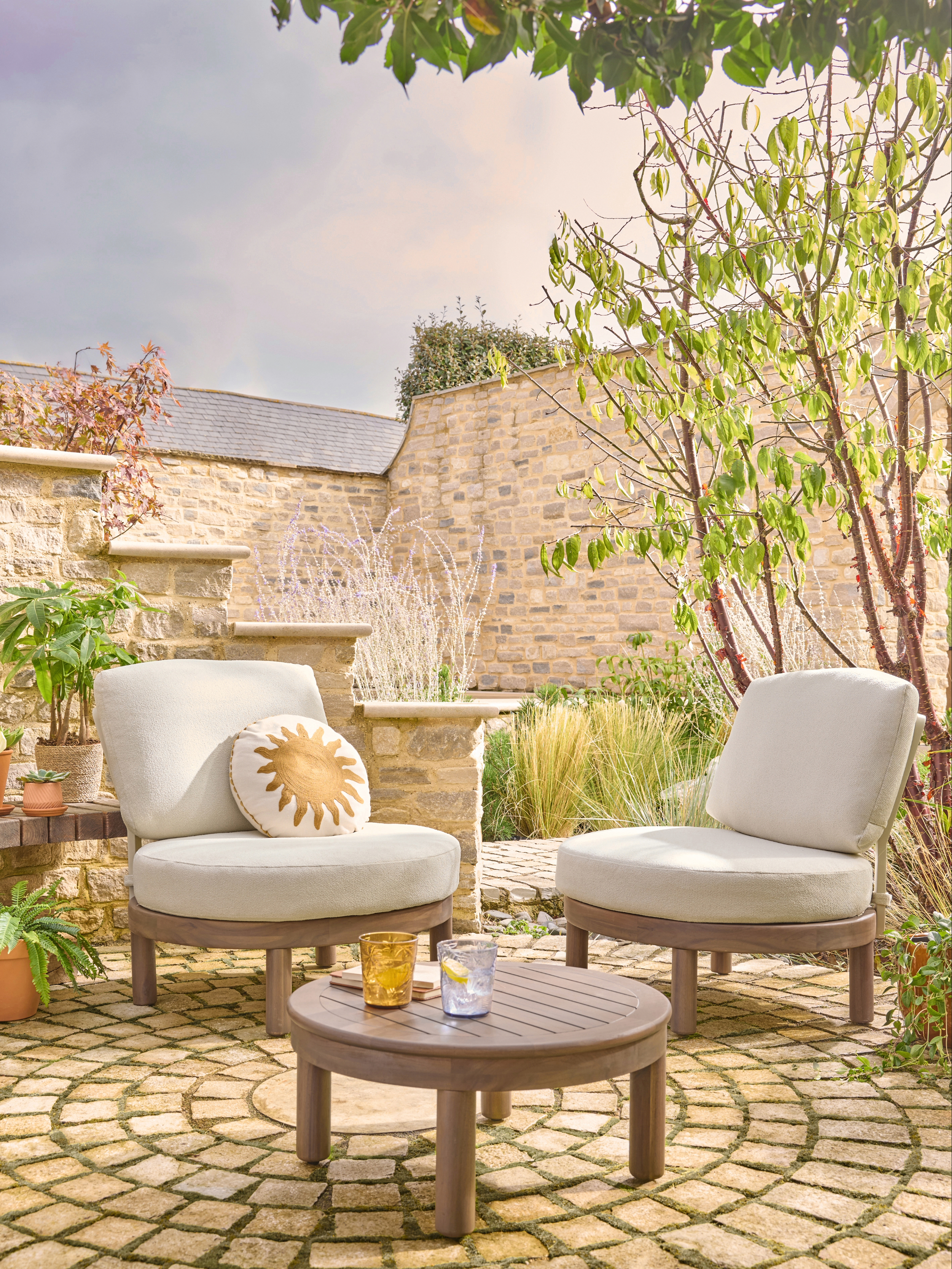 Outdoor armchairs upholstered in cream boucle