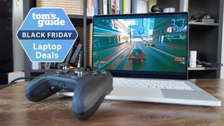 Asus ROG Zephyrus G14 on table with Xbox controller with Tom's Guide Black Friday Laptop Deals badge