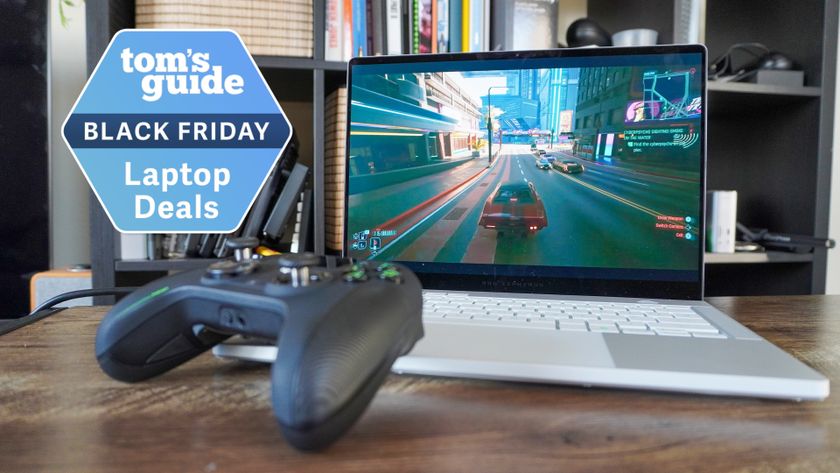 Asus ROG Zephyrus G14 on table with Xbox controller with Tom&#039;s Guide Black Friday Laptop Deals badge