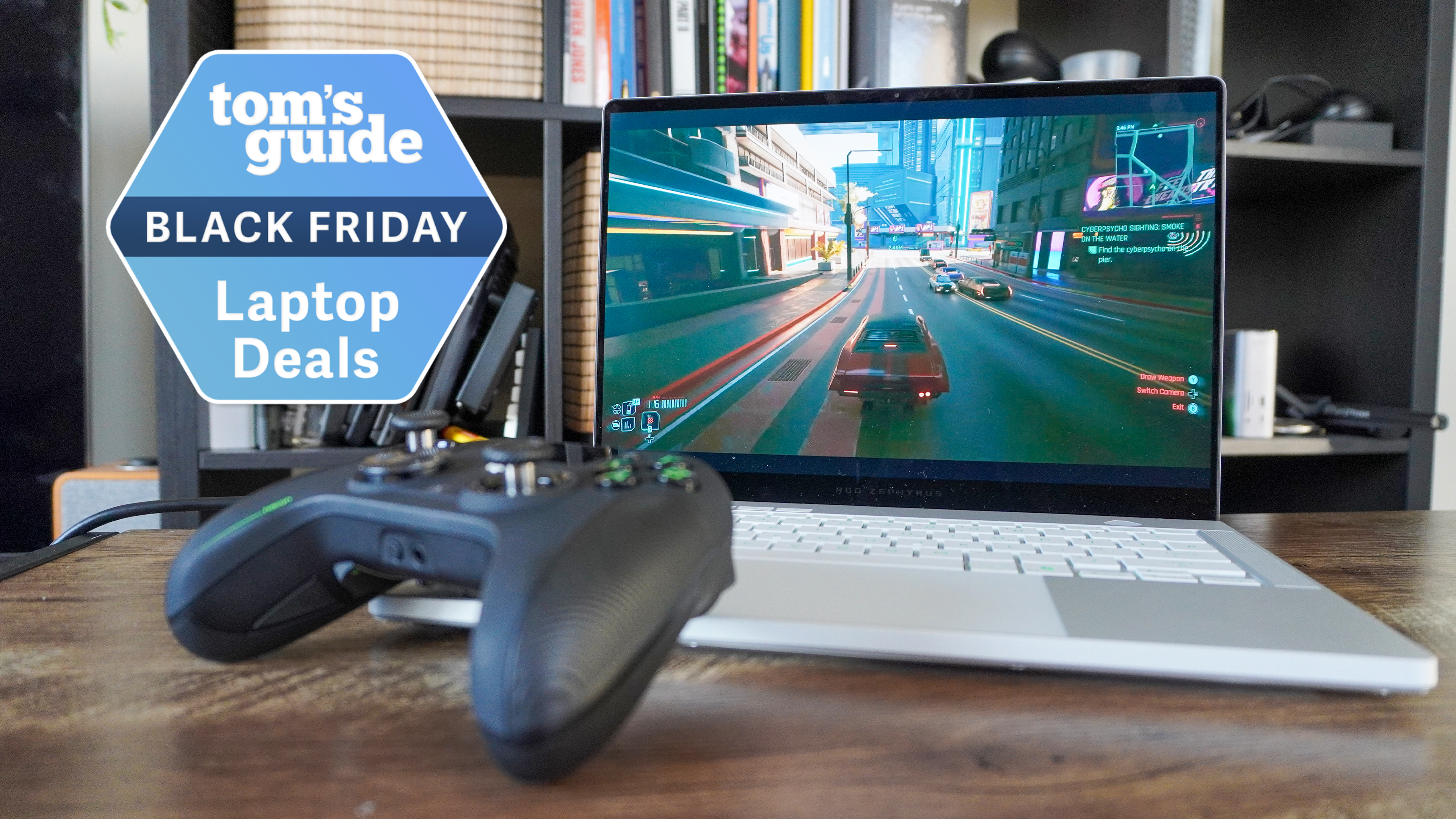 Asus ROG Zephyrus G14 on table with Xbox controller with Tom's Guide Black Friday Laptop Deals badge