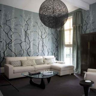 living room with dramatic wallpaper and sofa set