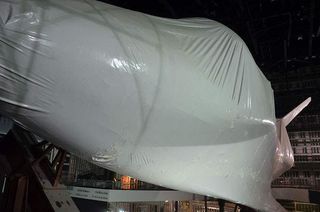 Space shuttle Atlantis, as seen shrink wrapped and angled for its display in the "Space Shuttle Atlantis" building, Feb. 21, 2013.