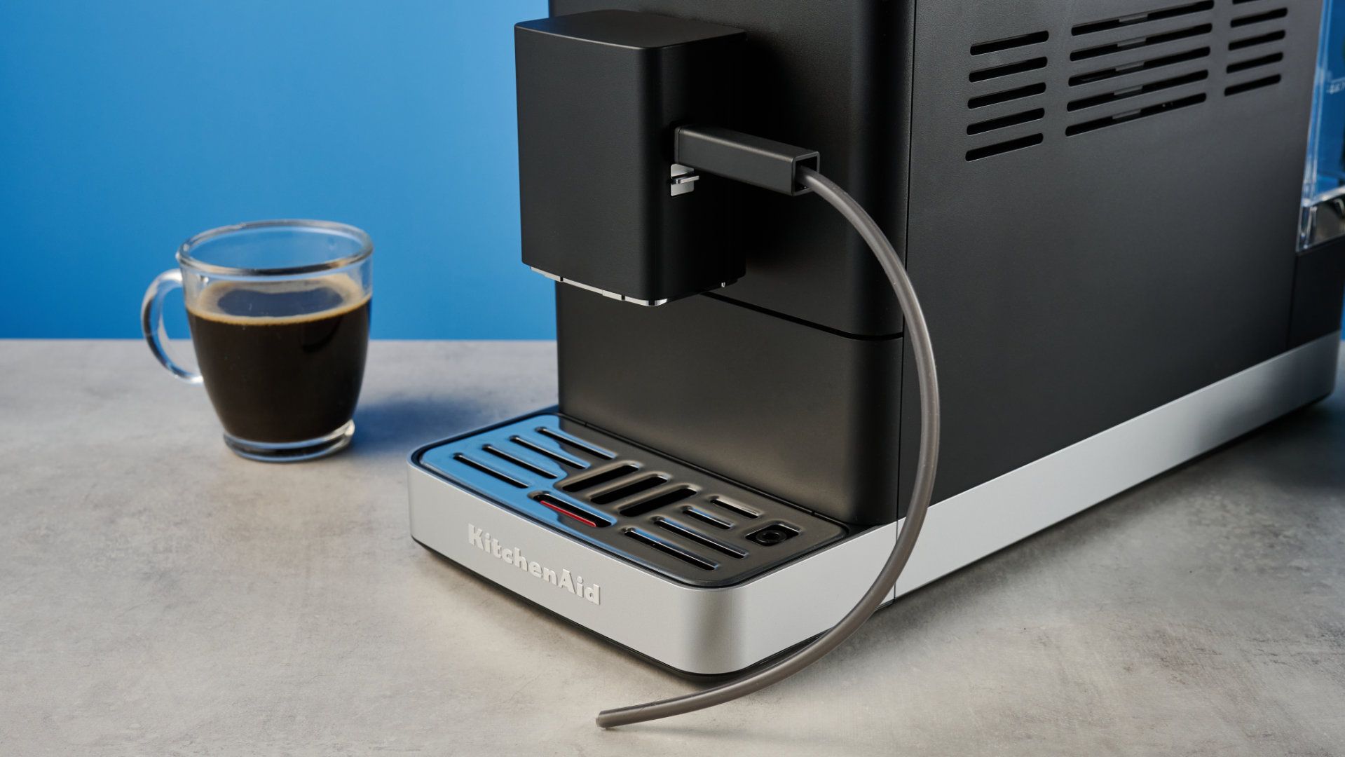 the kitchenaid kf3 superautomatic coffee machine photographed against a blue tom's guide background