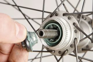 Image shows a Shimano cup and cone hub being serviced