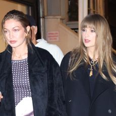 Gigi Hadid and Taylor Swift wearing black coats to go to Zero Bond in NYC