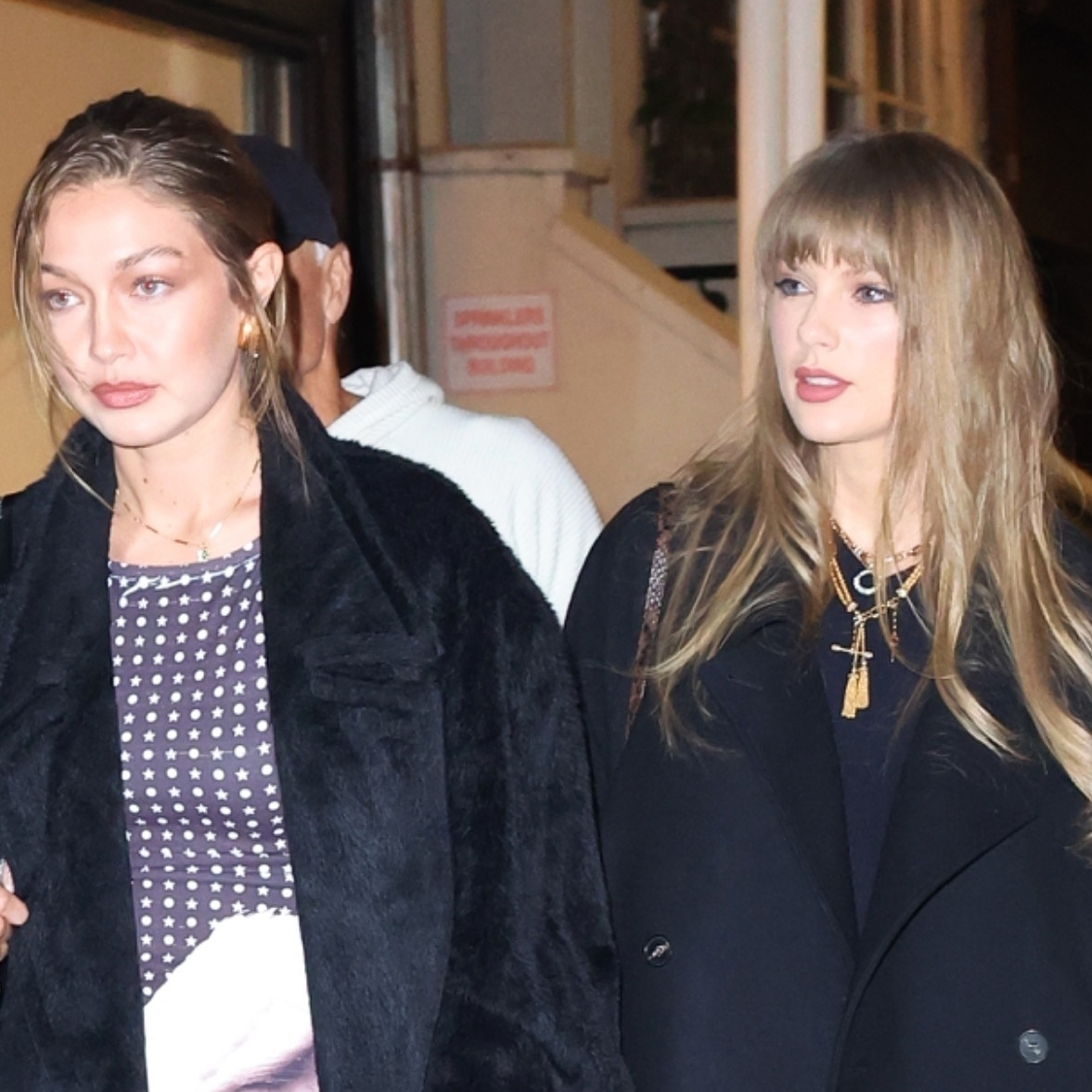 Gigi Hadid and Taylor Swift wearing black coats to go to Zero Bond in NYC