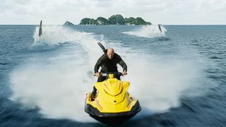 Jonas Taylor (Jason Statham) distracting the megs on a jet ski in Meg 2: The Trench.