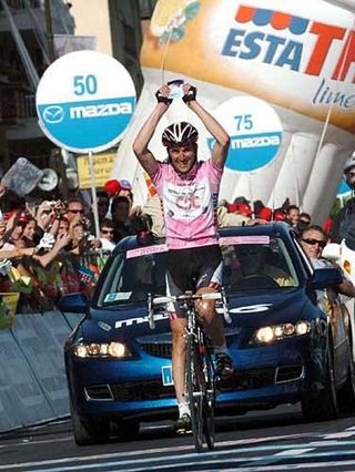 Ivan Basso holds aloft
